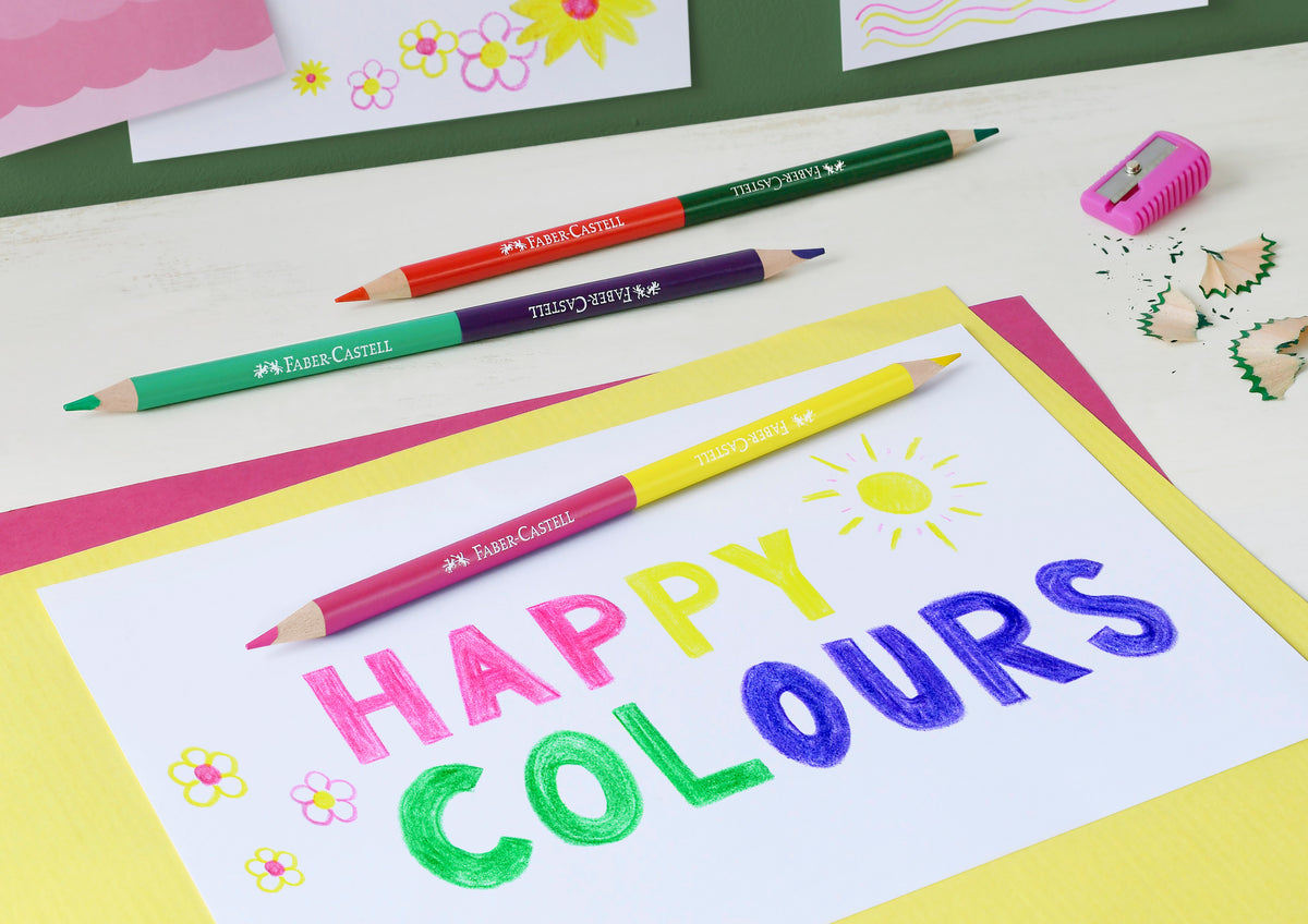 An image of colour pencils being used by Faber Castell. This pack includes 3 double ended colour pencils that are shown here being used to colour in the words HAPPY COLOURS.
