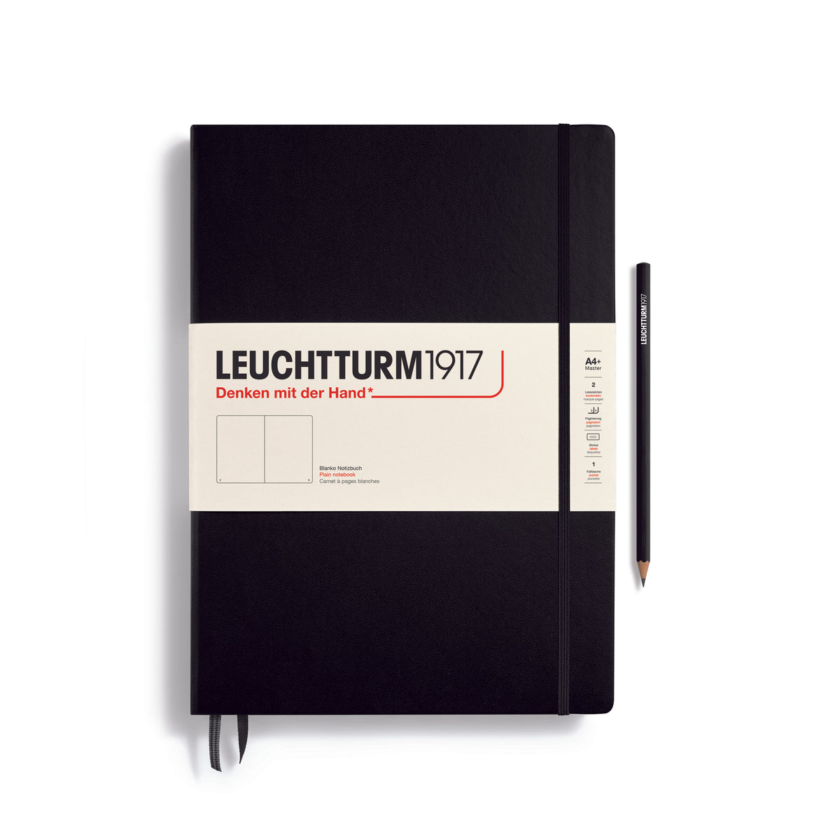 A large black notebook with a white paper band around it with the logo of the brand Leuchtturm1917. Below this is an image of the page ruling inside - in this case, plain or blank. It has two page marker ribbons showing at the bottom near the binding and an elastic notebook closure holding it neatly together. A black Leuchtturm pencil is shown at the side of the book.