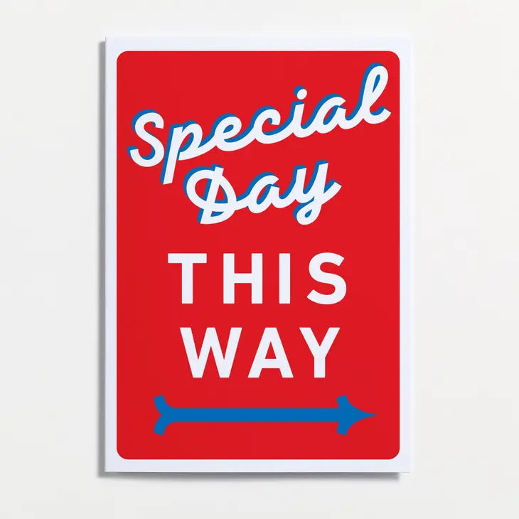 An image of a greetings card with a bright red background and white border. It has a vintage feel in the colouring and lettering style, with the words &#39;special day this way&#39; and a blue arrow pointing right. 