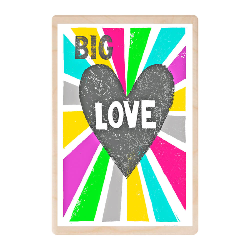 A wooden postcard featuring the a black heart with the word 'Love' in it, with rainbow coloured beams shooting from it. The whole phrase is Big Love.