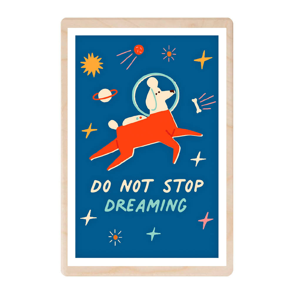 A wooden postcard with a royal blue background that's emulating space, featuring illustrations of a dog in space with a spacesuit, floating amongst stars , chasing a bone.