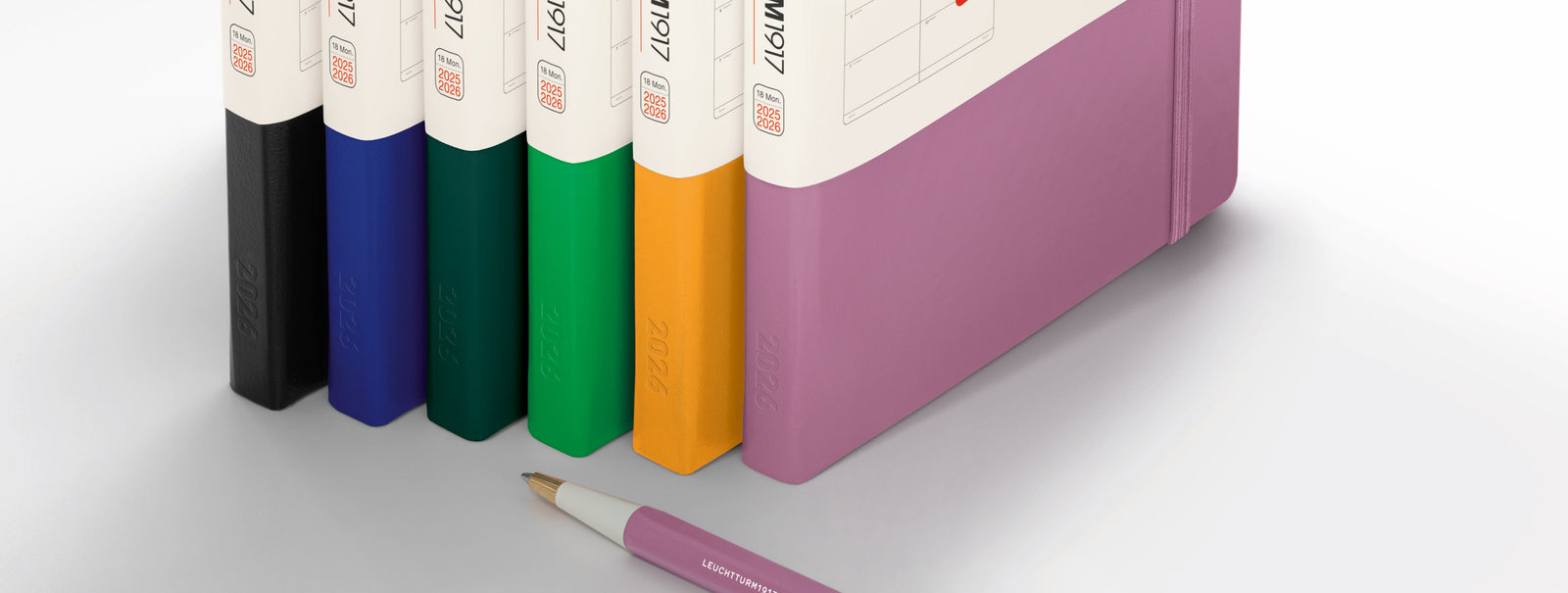 An apricot leuchtturm1917 weekly planner and notebook with a pencil