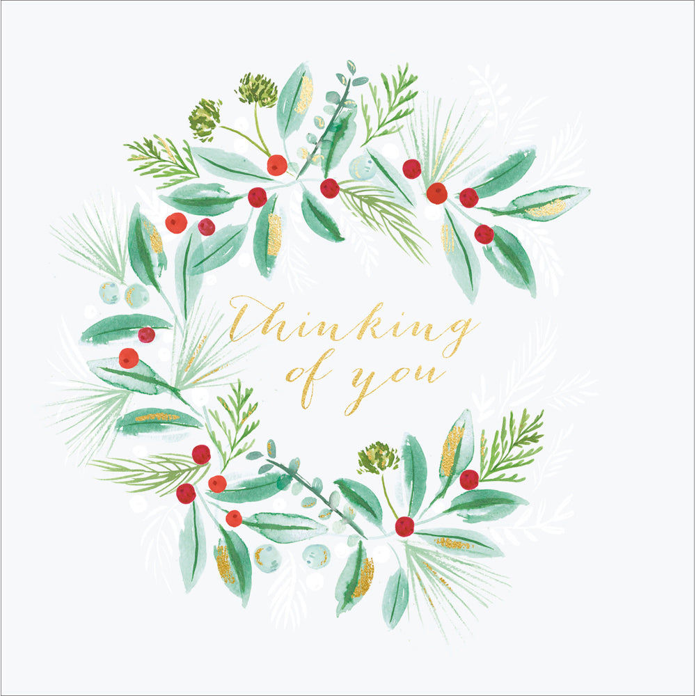 a compassionate christmas card with a sprig covered wreath illustrated and the words 'thinking of you'