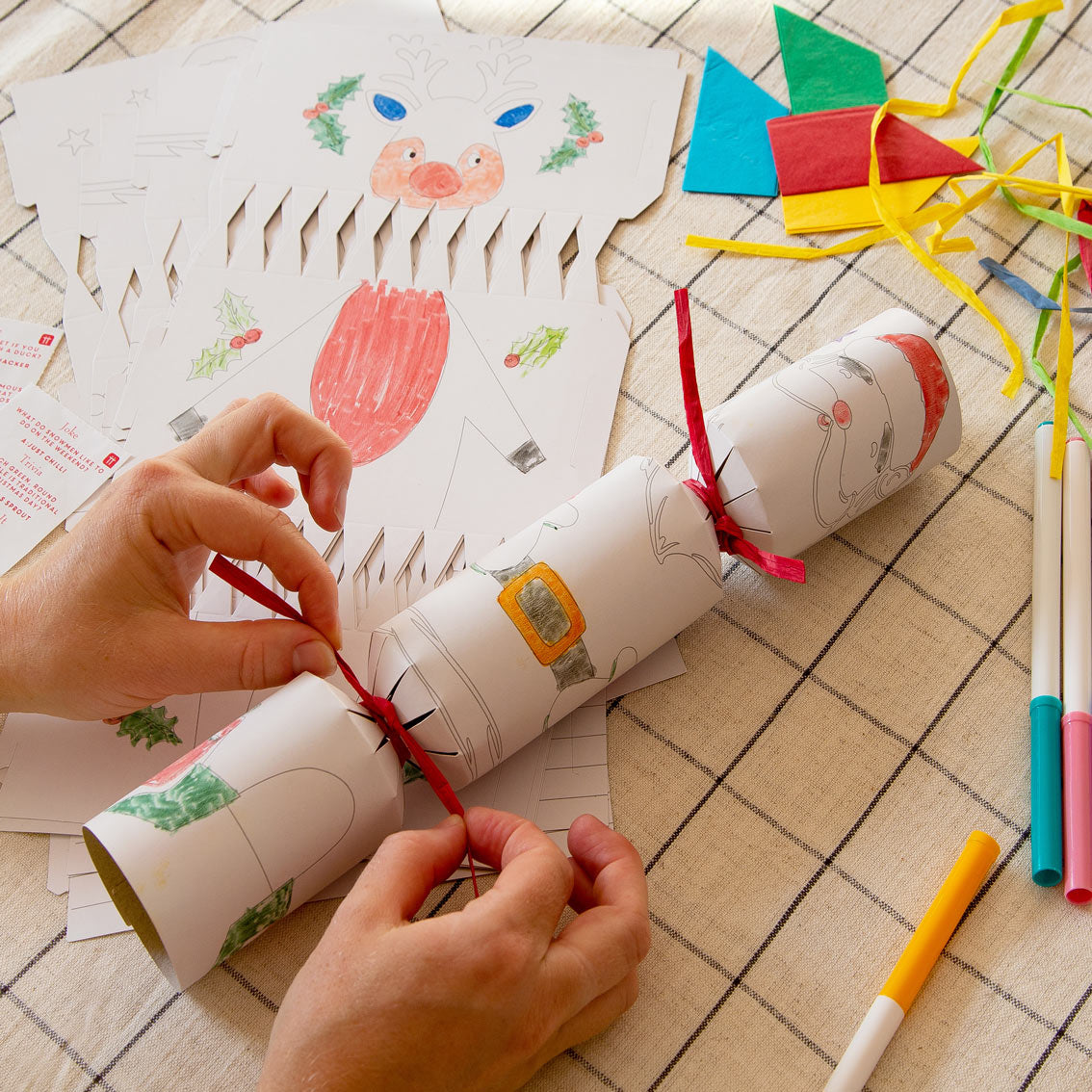 An image of someone making their own christmas cracker.