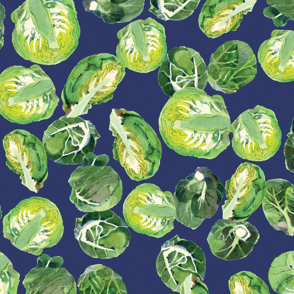 An image of a christmas tissue paper designed by emma Bridgewater which has a navy blue background and is covered in green brussels sprouts