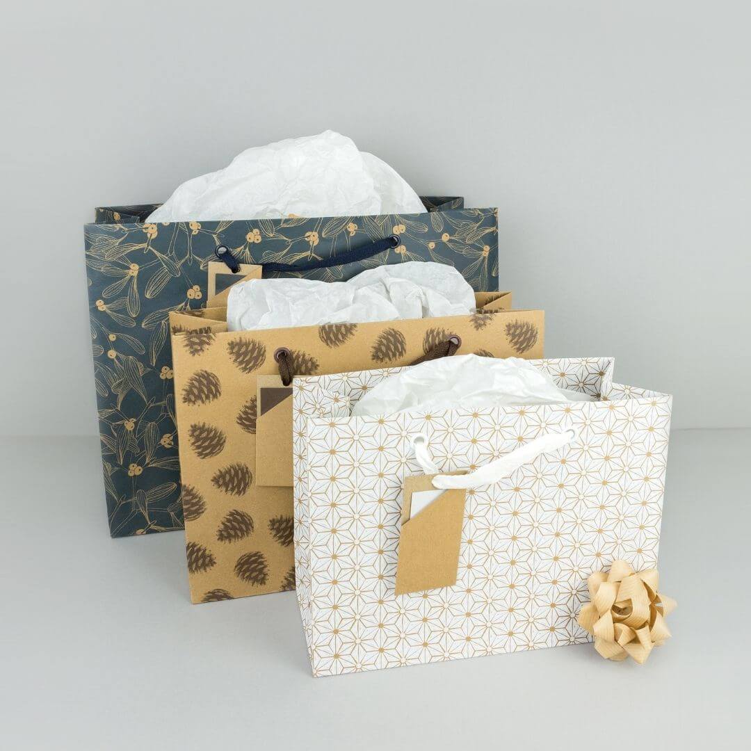 An image of 3 varying sized christmas gift bags.