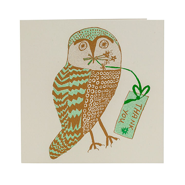 A greetings card with an illustration of an owl in brown and green. The owl is holding a note in it&#39;s mouth with the words &#39;thank you&#39; on it.