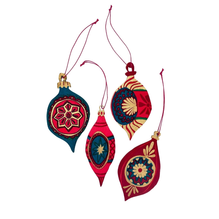 An image of 4 wooden vintae christmas decorations with red hanging loops attached to each. They are red, teal, pink and gold in colour.