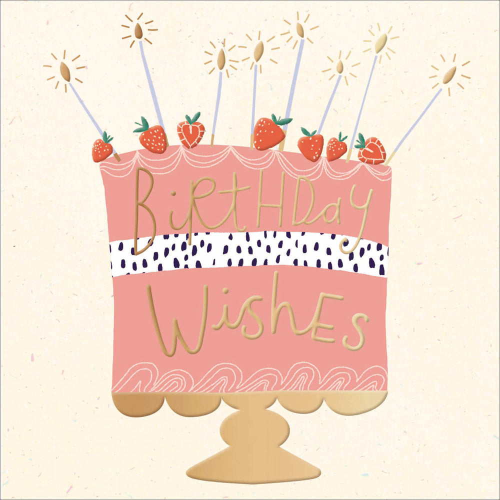 A greetings card with a cream background, featuring a very big pink coloured birthday cake on a cake stand. It&#39;s sitting on a gold cake stand and has strawberries on top and gold foil adorned candles too. The words &#39;birthday wishes&#39; feature on the cake in gold foil.