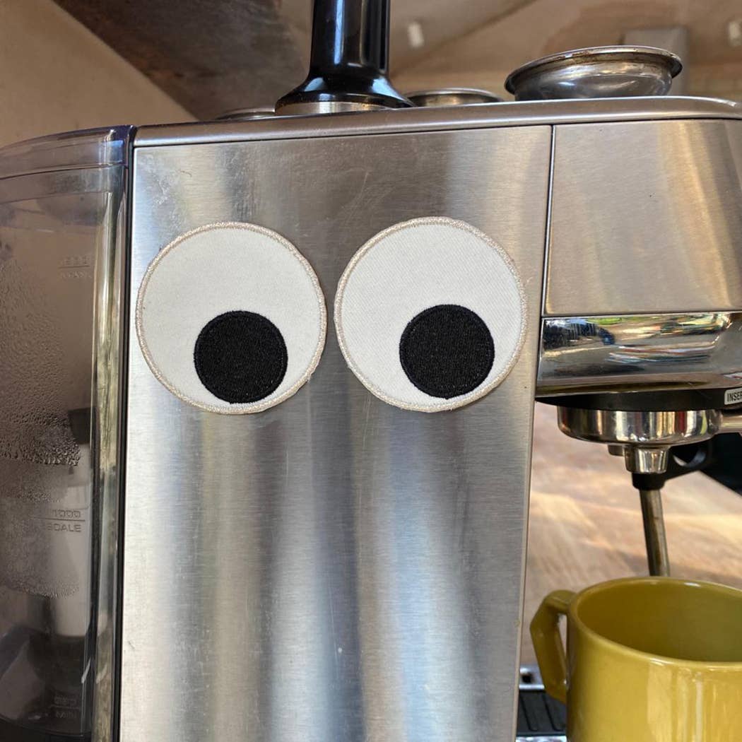 Giant Eyeball Magnets 2pk stuck to a coffee machine