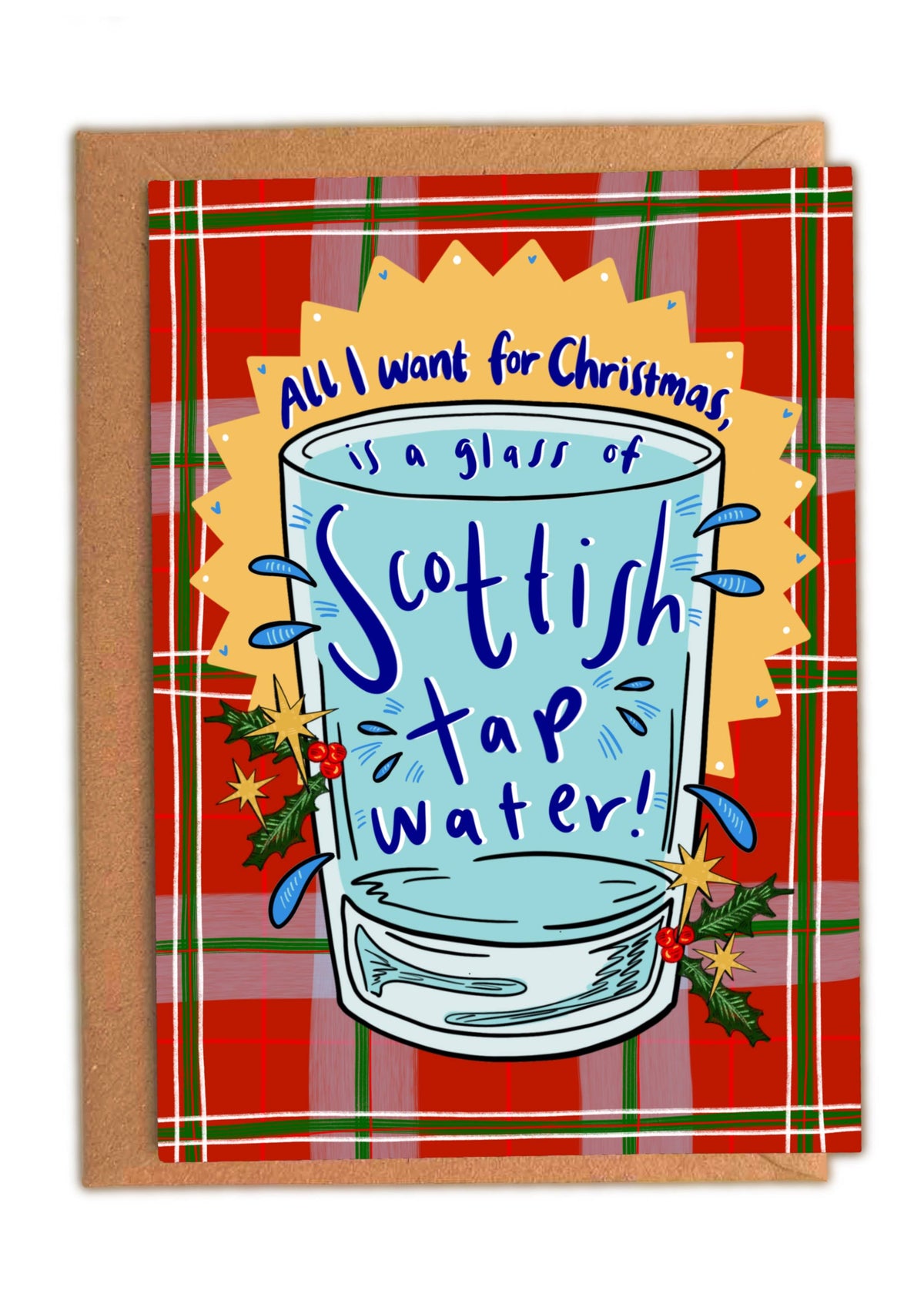 An A6 christmas greeting card with a brown envelope behind it, featuring a red tartan border and a central illustration of a glass of Scottish tap water with the text 'All I want for Christmas is a glass of Scottish tap water!'.