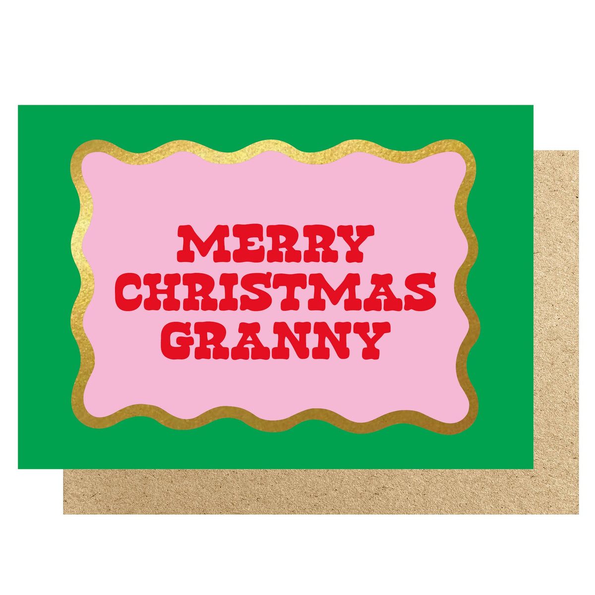 A Christmas greeting card with a bright green background, a pink central panel with a gold glitter border, and the words “MERRY CHRISTMAS GRANNY” in red block letters. A kraft paper envelope is partially visible behind the card.