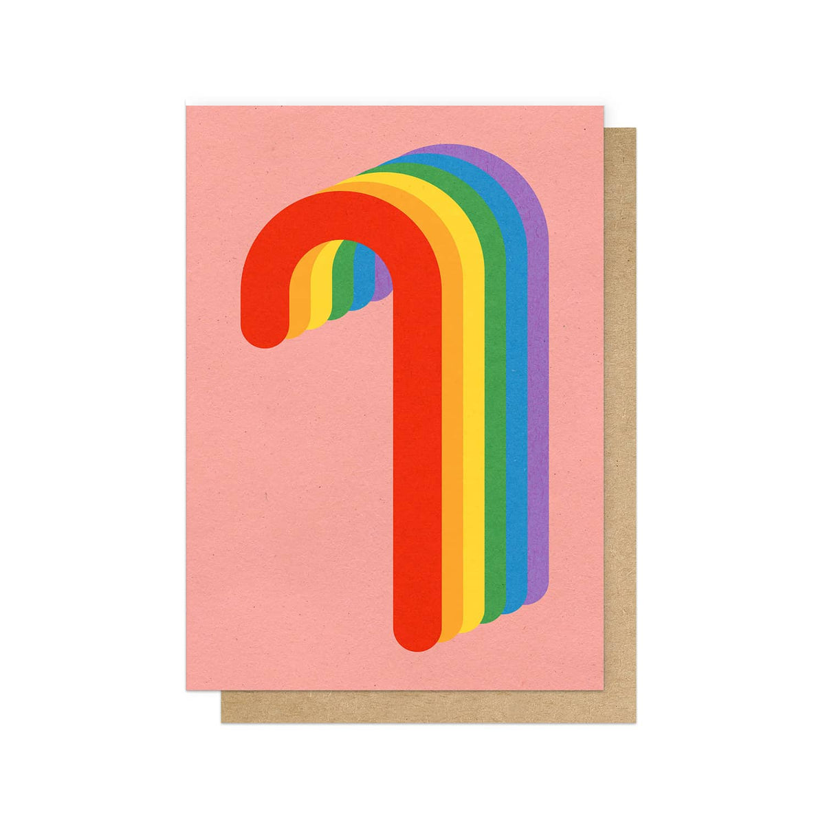 A pink christmas card featuring a stylised candy cane made from overlapping rainbow stripes, shown with a brown kraft envelope behind it on a white background.