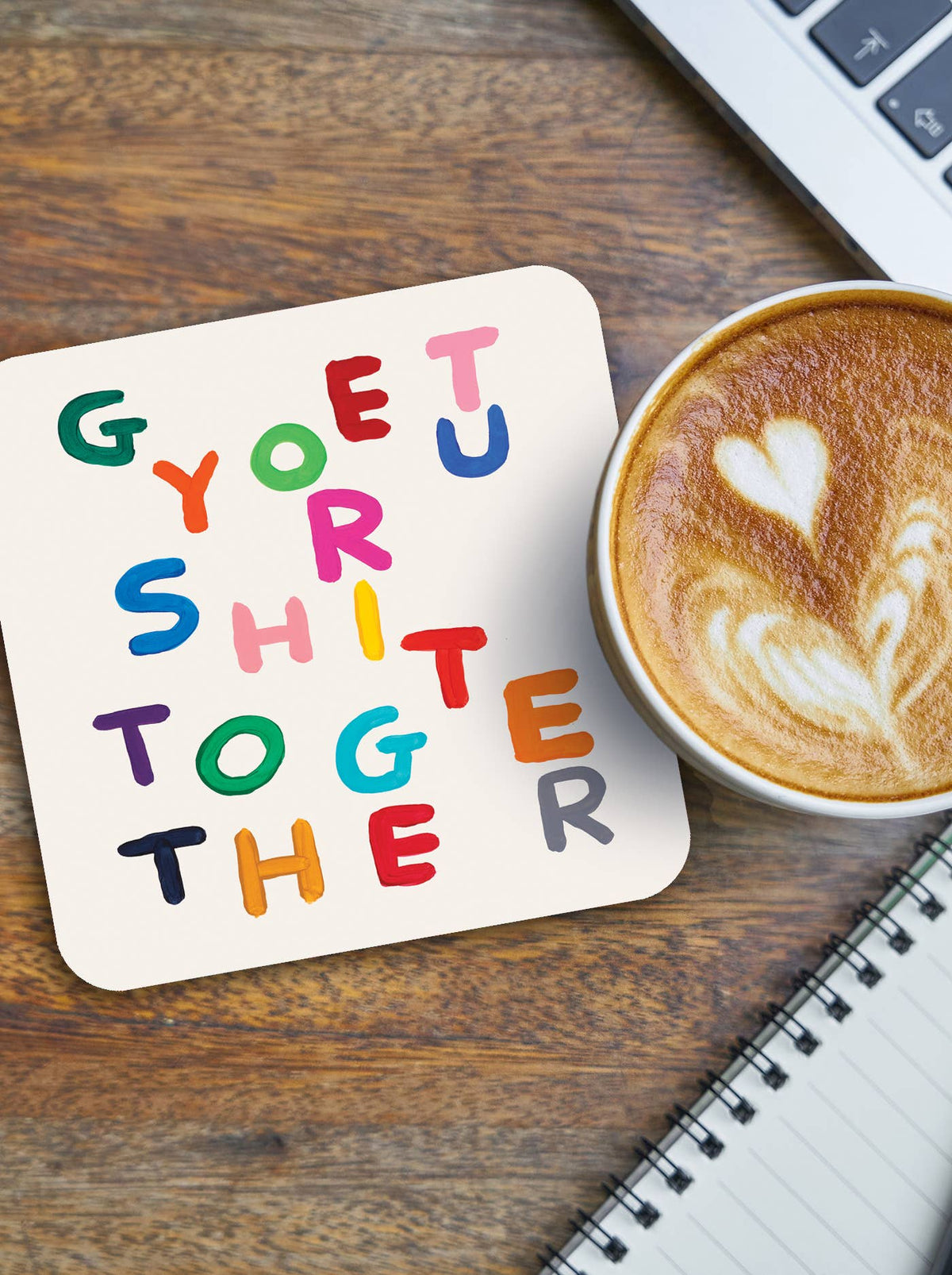 Get Your Shit Together David Shrigley Coaster shown on a desk by penny black