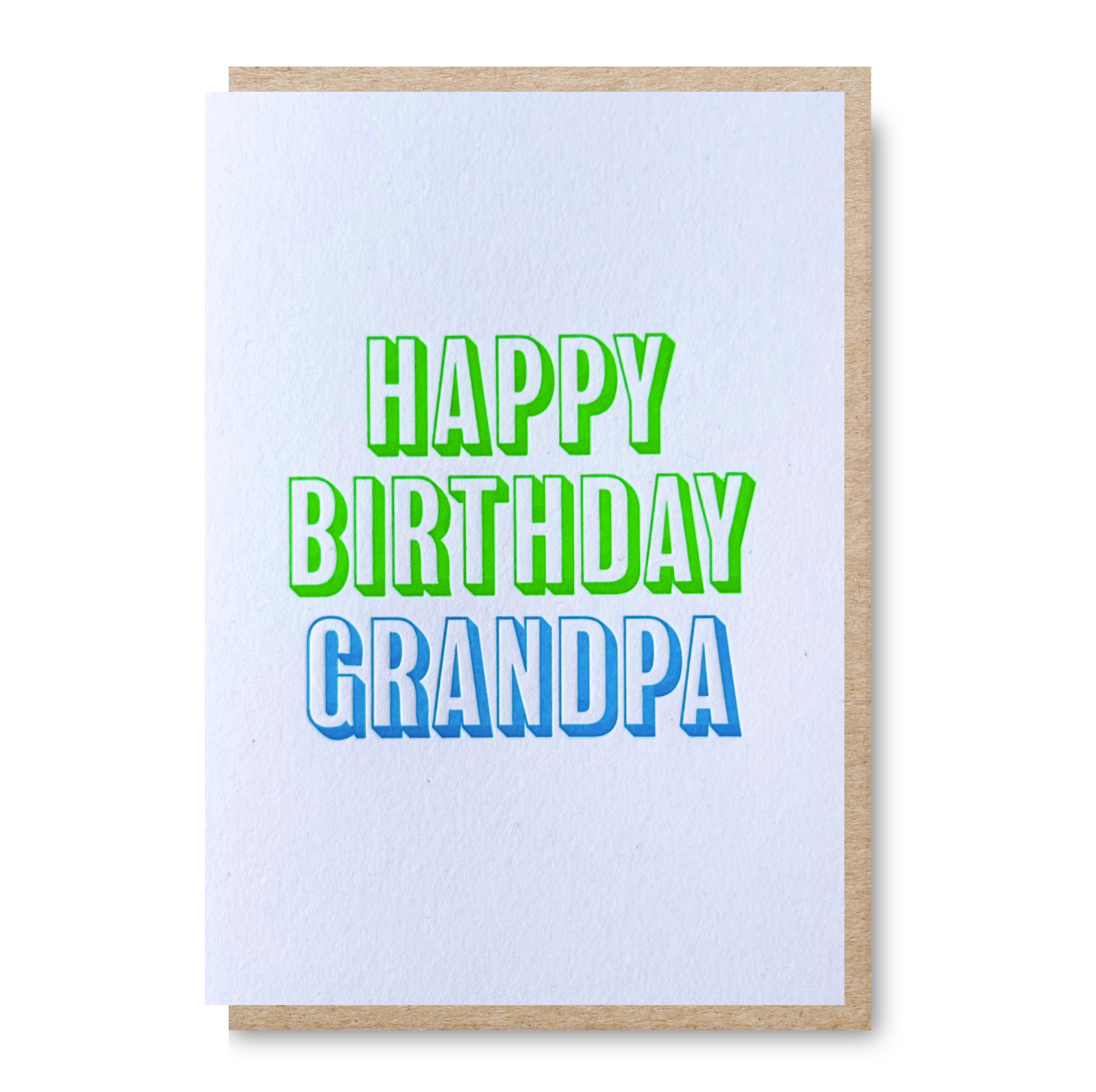 An A6 letterpress printed birthday card with a white textured front and a natural kraft envelope, featuring the text 'HAPPY BIRTHDAY GRANDPA' in bright green and blue lettering.