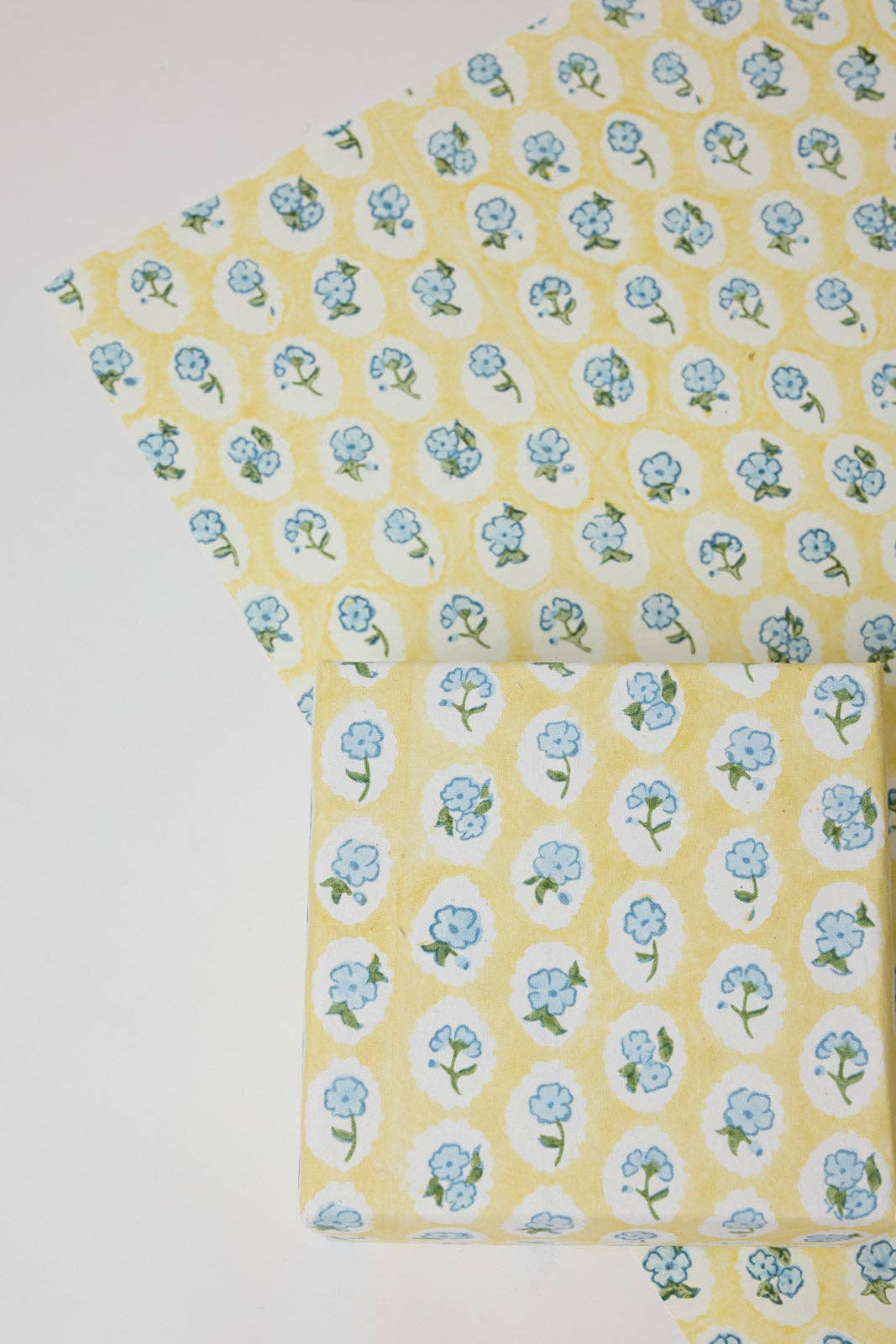 Floral Scallop Tiles Block Printed Wrapping Paper Sheet by penny black shown wrapping a gift