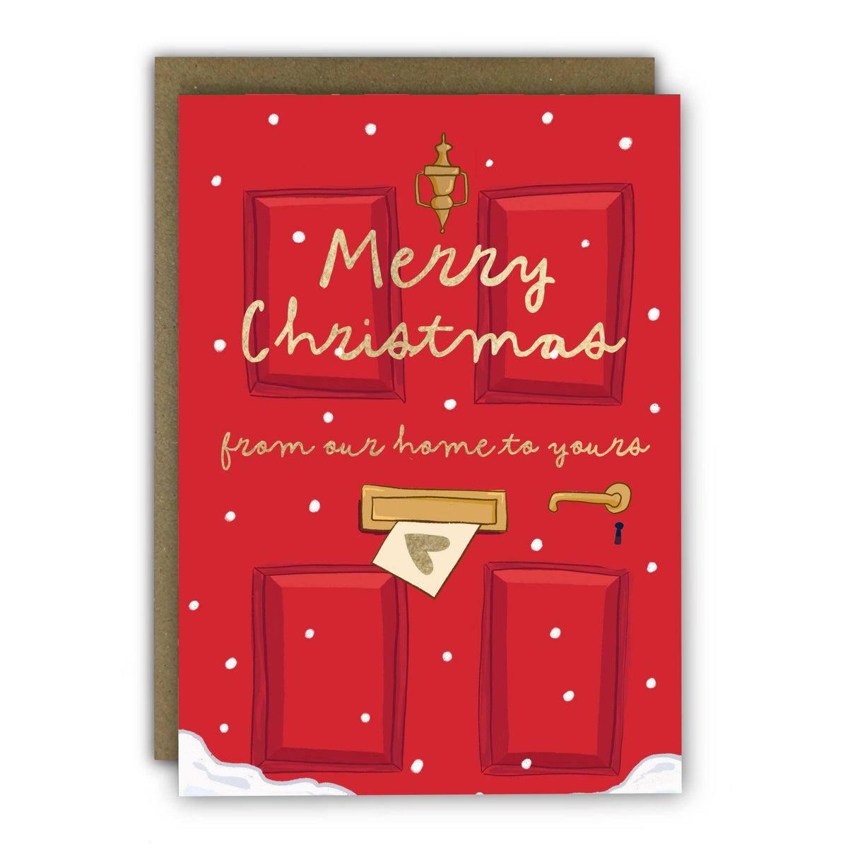 A red Christmas greeting card with a brown envelope behind it. The card features an illustrated red door with snowflakes, gold lettering that reads 'Merry Christmas from our home to yours,' a gold bell, mail slot, and key, plus small white snow details at the bottom at penny black