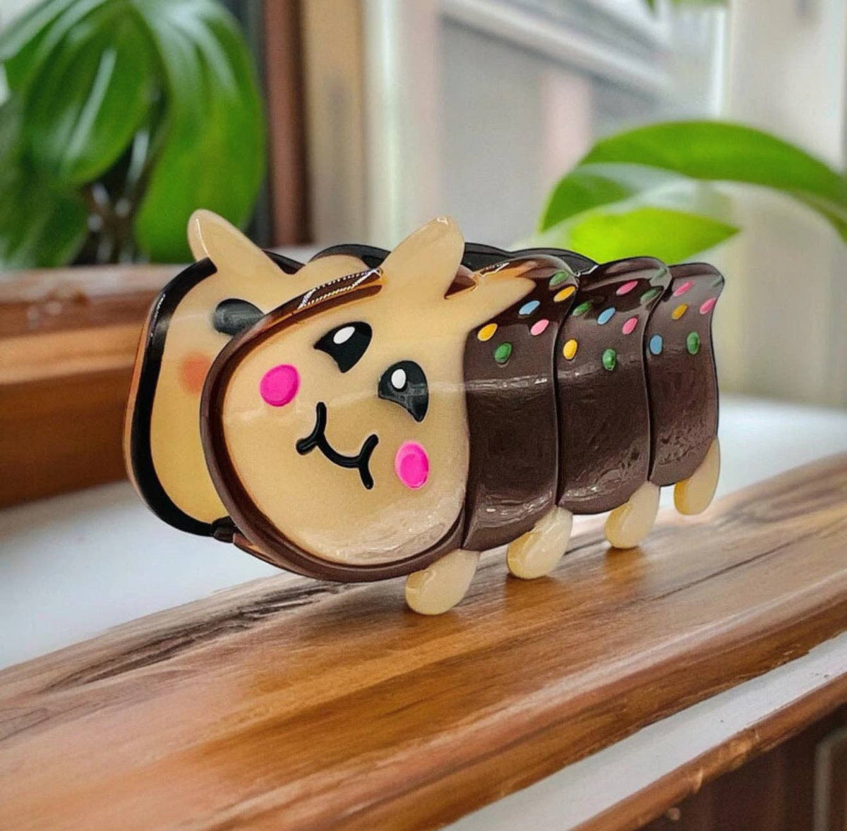 Caterpillar Cake Birthday Hair Claw by penny black shown standing up