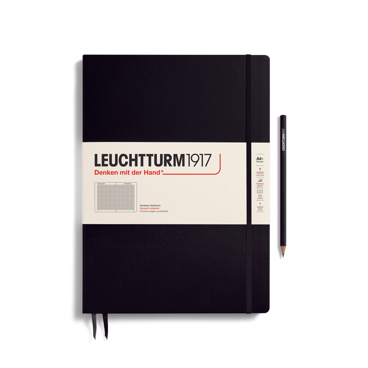 A large black notebook with a white paper band around it with the logo of the brand Leuchtturm1917. Below this is an image of the page ruling inside - in this case, squared. It has two page marker ribbons showing at the bottom near the binding and a matching colour elastic notebook closure holding it neatly together. A black LEUCHTTURM1917 pencil is shown at the side of the book for size reference.
