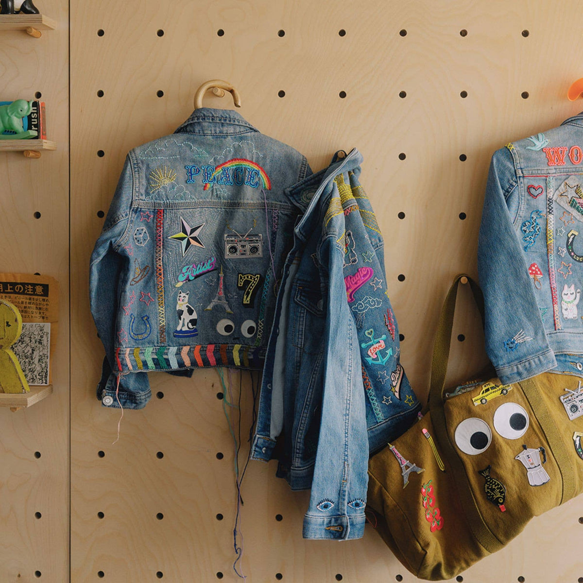 Colourful Iron on Patch - Drama Queen by penny black showing back of denim jacket with lots of patches