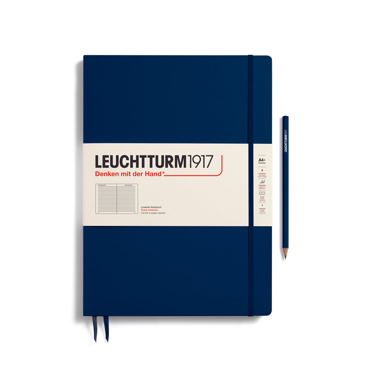 A large navy blue notebook with a white paper band around it with the logo of the brand Leuchtturm1917. Below this is an image of the page ruling inside - in this case, ruled. It has two page marker ribbons showing at the bottom near the binding and a matching colour elastic notebook closure holding it neatly together. A navy blue LEUCHTTURM1917 pencil is shown at the side of the book for size reference.