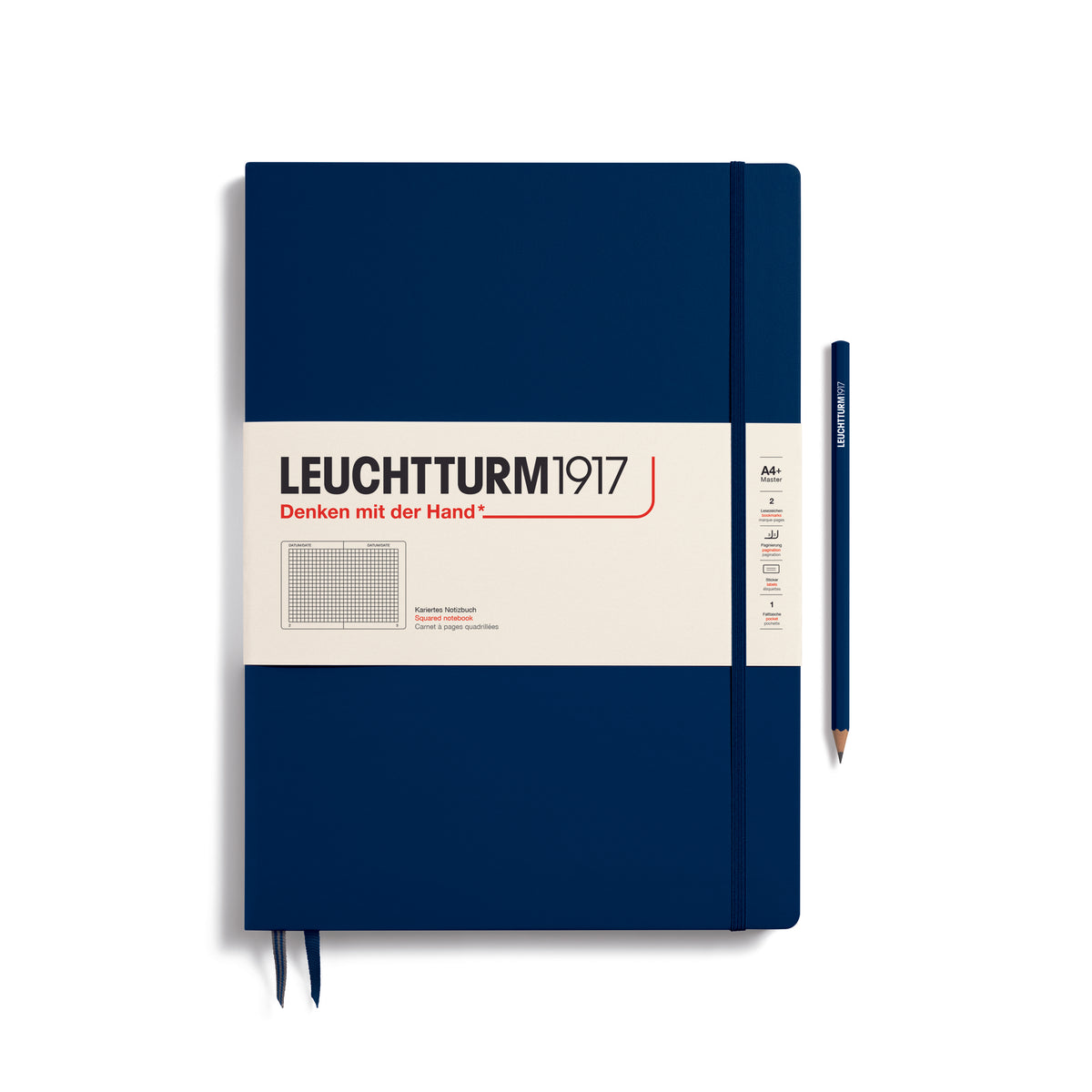 A large navy blue notebook with a white paper band around it with the logo of the brand Leuchtturm1917. Below this is an image of the page ruling inside - in this case, squared. It has two page marker ribbons showing at the bottom near the binding and a matching colour elastic notebook closure holding it neatly together. A navy blue LEUCHTTURM1917 pencil is shown at the side of the book for size reference.