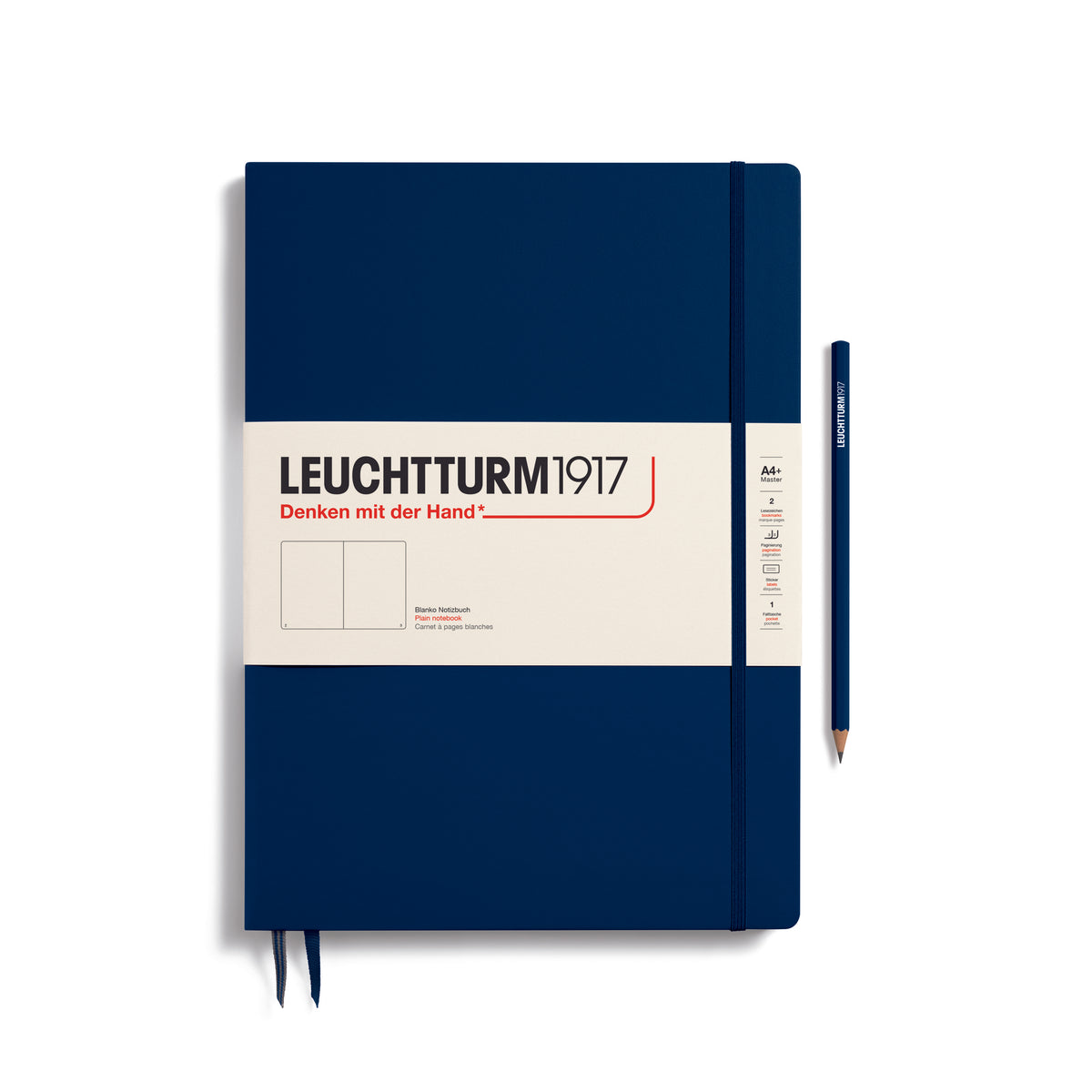 A large navy blue notebook with a white paper band around it with the logo of the brand Leuchtturm1917. Below this is an image of the page ruling inside - in this case, plain. It has two page marker ribbons showing at the bottom near the binding and a matching colour elastic notebook closure holding it neatly together. A navy blue LEUCHTTURM1917 pencil is shown at the side of the book for size reference.