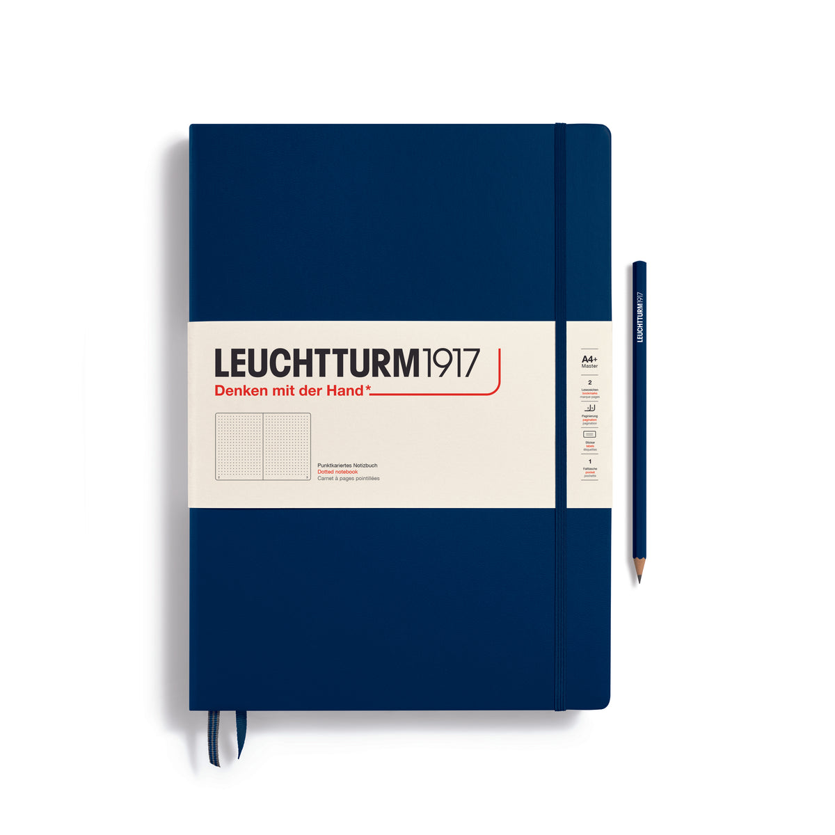 A large dark blue notebook with a white paper band around it with the logo of the brand Leuchtturm1917. Below this is an image of the page ruling inside - in this case, dotted. It has two page marker ribbons showing at the bottom near the binding and a matching colour elastic notebook closure holding it neatly together. A dark blue Leuchtturm pencil is shown at the side of the book.