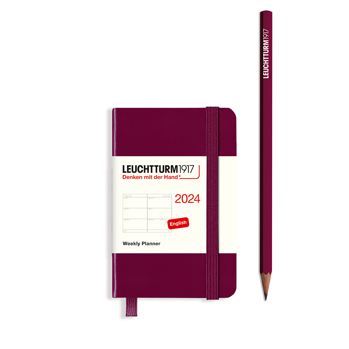 An image of a burgundy planner with a burgundy elastic band holding it together and a cream paper wrap around the middle stating the business name Leuchtturm1917, that it is for the year 2024, it is a weekly planner, is A7 in size and an English language version. It has an image on the wrap showing the inside layout which is a week spread across 2 pages. A burgundy pencil is shown at the side of the planner.