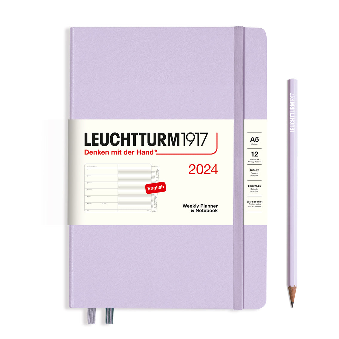 An image of a lilac planner with a lilac elastic band holding it together and a cream paper wrap around the middle stating the business name Leuchtturm1917, that it is for the year 2024, it is a weekly planner and notebook, is A5 in size and an English language version. It has an image on the wrap showing the inside layout which is a week on the left hand page and a notes page on thr right hand page. A lilac pencil is shown at the side of the planner.