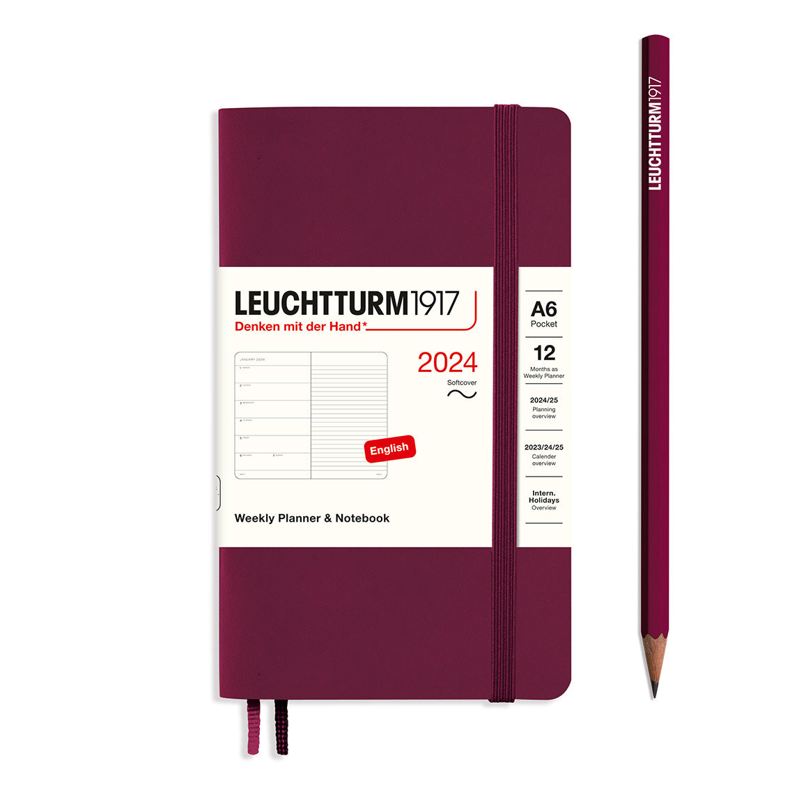 An image of a burgundy planner with a burgundy elastic band holding it together and a cream paper wrap around the middle stating the business name Leuchtturm1917, that it is for the year 2024, it is a weekly planner and notebook, is A6 in size and an English language version. It has an image on the wrap showing the inside layout which is a week on the left hand page and a notes page on thr right hand page. A burgundy pencil is shown at the side of the planner.