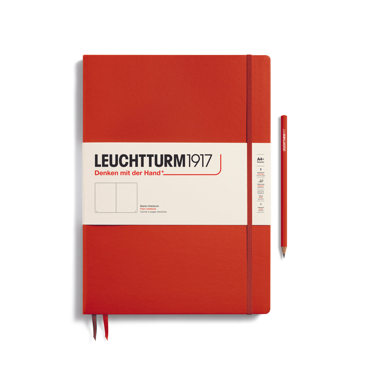 A large fox red colour notebook with a white paper band around it with the logo of the brand Leuchtturm1917. Below this is an image of the page ruling inside - in this case, plain. It has two page marker ribbons showing at the bottom near the binding and a matching colour elastic notebook closure holding it neatly together. A fox red colour LEUCHTTURM1917 pencil is shown at the side of the book for size reference.