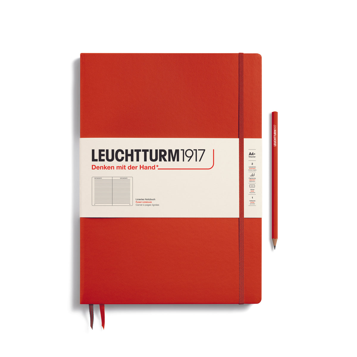 A large fox red colour notebook with a white paper band around it with the logo of the brand Leuchtturm1917. Below this is an image of the page ruling inside - in this case, ruled. It has two page marker ribbons showing at the bottom near the binding and a matching colour elastic notebook closure holding it neatly together. A fox red colour LEUCHTTURM1917 pencil is shown at the side of the book for size reference.