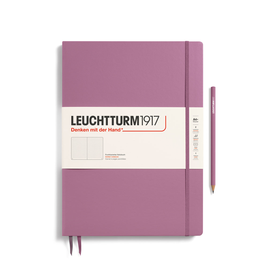 A large dusty rose colour notebook with a white paper band around it with the logo of the brand Leuchtturm1917. Below this is an image of the page ruling inside - in this case, dotted. It has two page marker ribbons showing at the bottom near the binding and a matching colour elastic notebook closure holding it neatly together. A dusty rose colour LEUCHTTURM1917 pencil is shown at the side of the book for size reference.