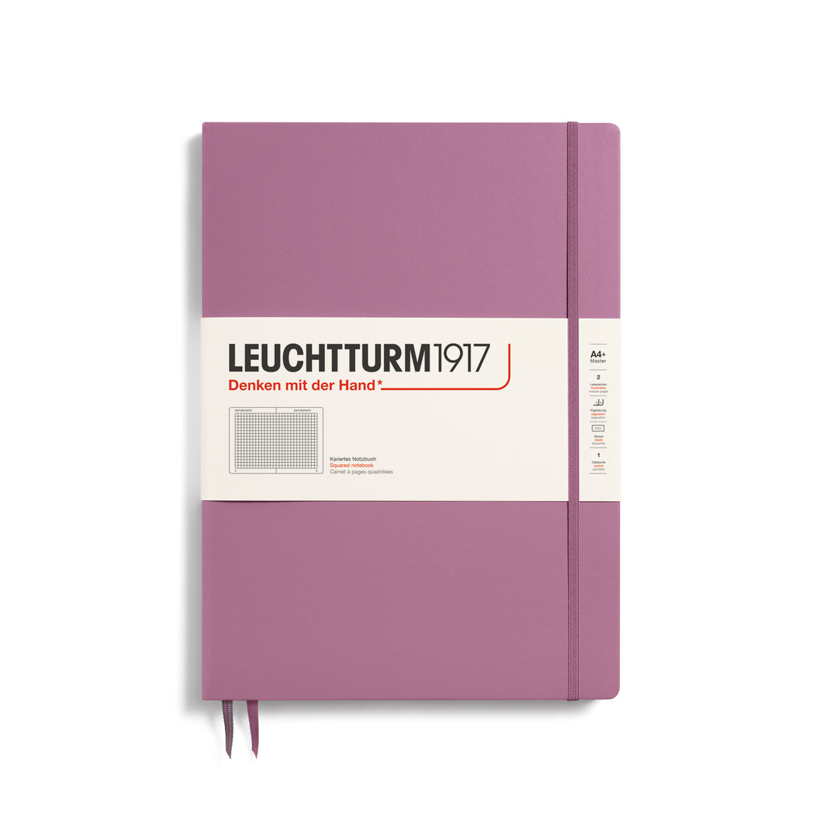 A large dusty rose colour notebook with a white paper band around it with the logo of the brand Leuchtturm1917. Below this is an image of the page ruling inside - in this case, squared. It has two page marker ribbons showing at the bottom near the binding and a matching colour elastic notebook closure holding it neatly together. 