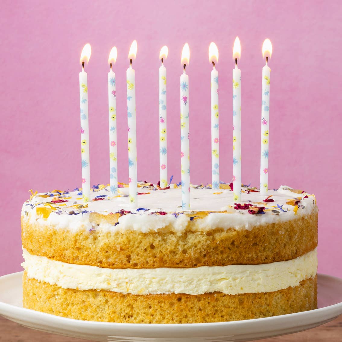 Pastel Flowery Print Candles 16pk shown lit on a cake by penny black