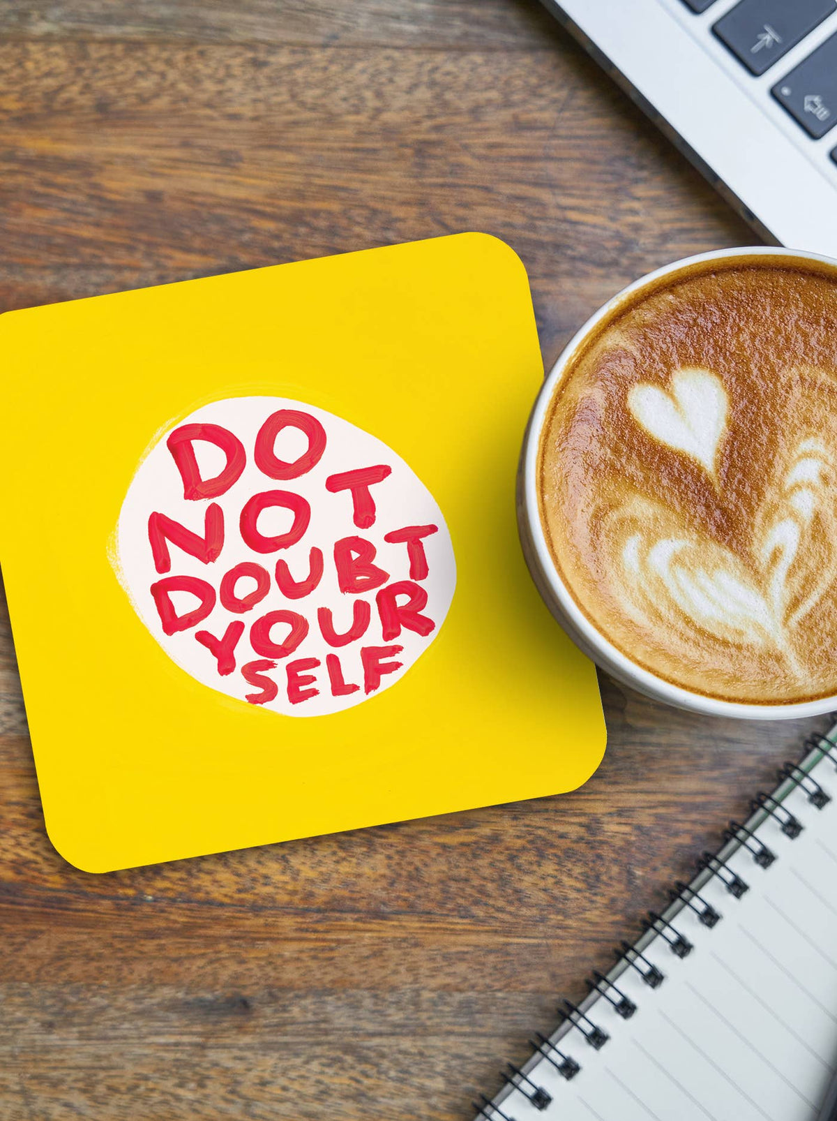 Do Not Doubt Yourself David Shrigley Coaster by penny black shown on a taletop with a coffee