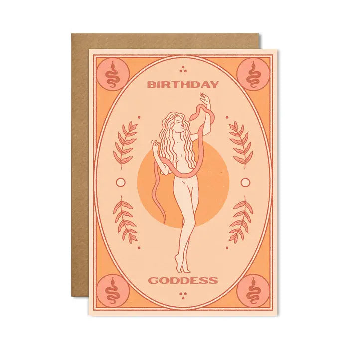 A greetings card with an orange frame around the side and an image of a cream and orange outlined naked figure in the centre. The figure is handling a snake and is standing infront of an orange sun. There are snakes and foliage around the figure. The words &#39;birthday goddess&#39; feature in orange around the figure.