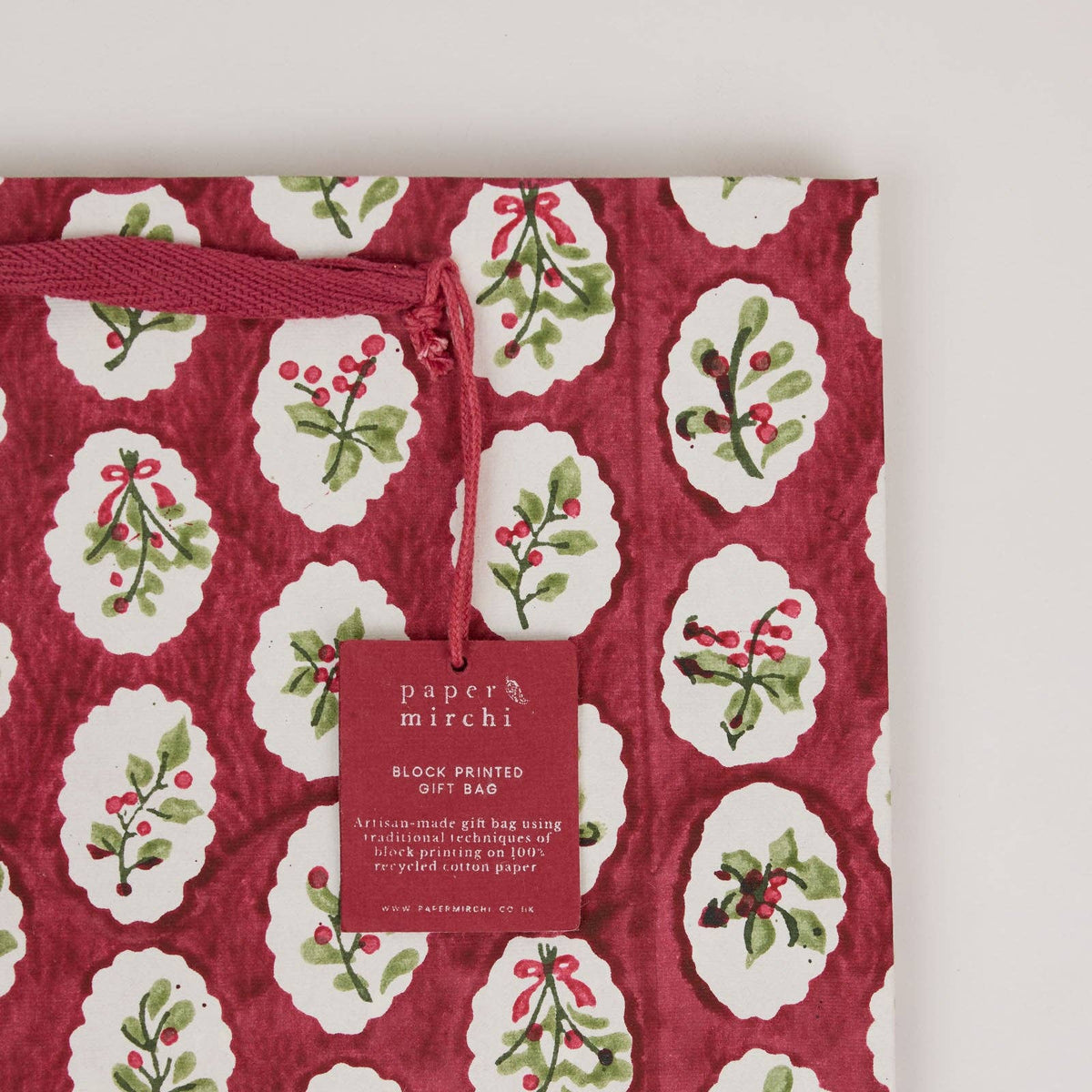 Close up of a Festive foliage scallop design block printed gift bag by paper mirchi and penny black