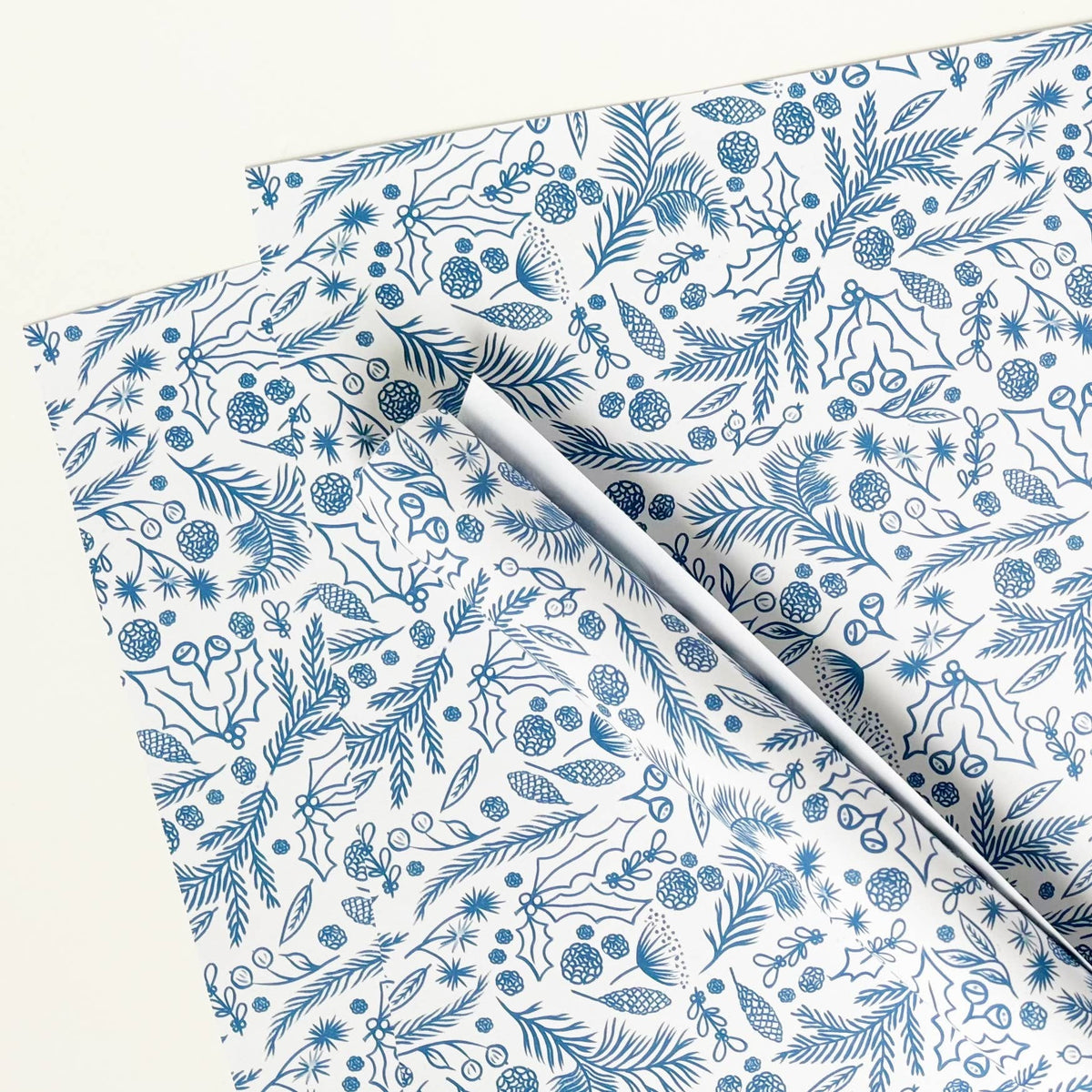 White gift wrap paper with blue floral and nature pattern by Lomond Paper Co at Penny Black.