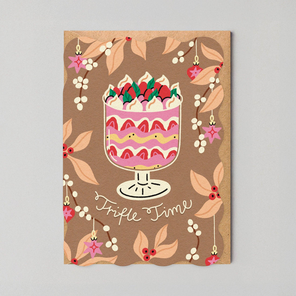 A wavy die cut Christmas Card with a trifle illustration and 'Trifle Time' text on a brown background. 
