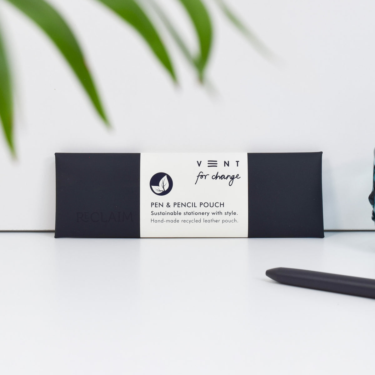 A black pen and pencil pouch made of recycled leather and has the word &#39;Reclaim&#39; embossed in it.