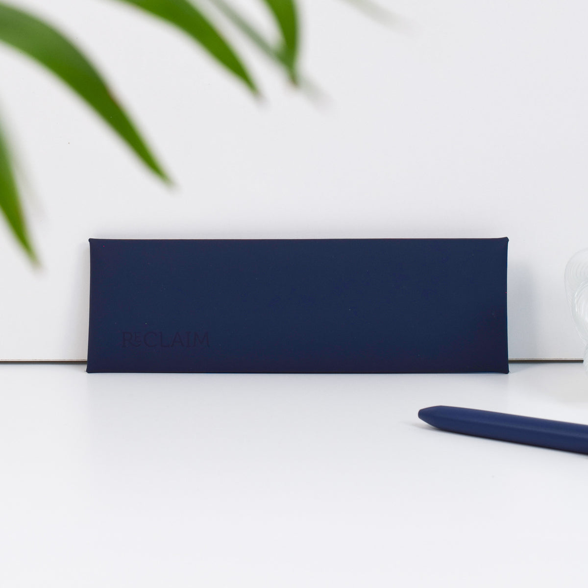 A navy blue pen and pencil pouch made of recycled leather - showing the pouch without packaging.