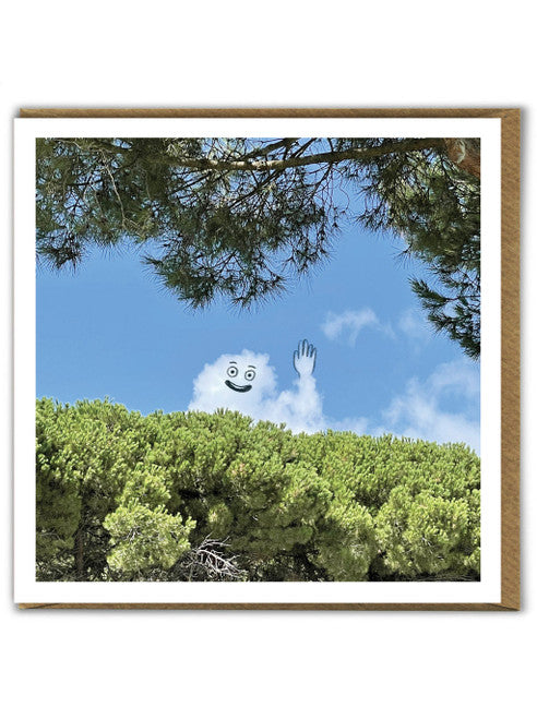 A greetings card showing a cloudy sky where the clouds have been made to look like someone waving over a hedge using a black pen.
