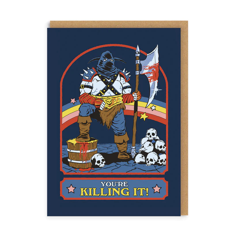 A navy blue greetings card featuring an illustration of a hooded and masked person holding a grim shiny and bloody blade, having just decapitated some skeletons. There is a stack of skulls on the ground and a retro coloured rainbow in the background. Under the illustration is a box with the words &#39;You&#39;re killing it&#39; in block coloured capital letters. A kraft brown envelope is shown to accompany the card.