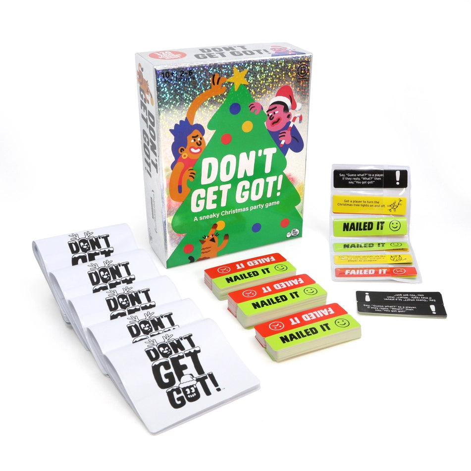 The card game 'Don't Get Got!' with its illustrated box, cards, and contents arranged on a clean white background. The box features festive Christmas-themed artwork with cartoon characters and the title 'DON'T GET GOT!'. Lots of cards are laid out in front of it.
