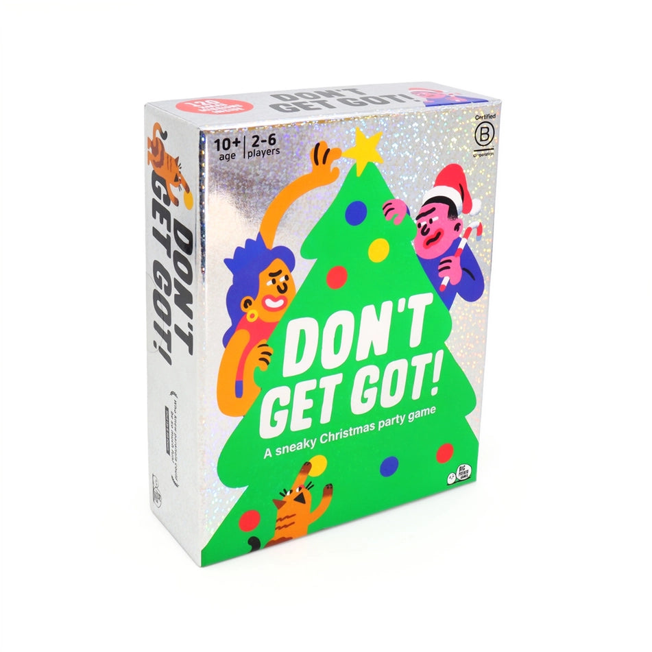 The card game box for 'Don't Get Got!' is shown at a three-quarter angle on a clean white background. The packaging features a silver glittery background, a large green Christmas tree, and cartoon characters in festive holiday attire looking sneaky.