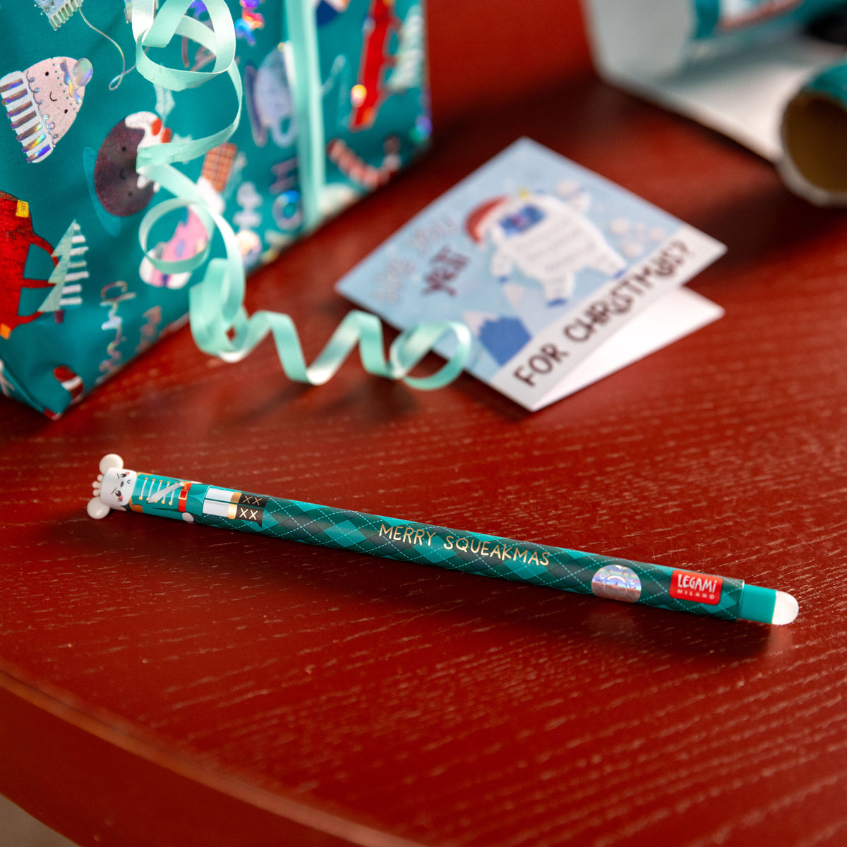 Nutcracker Erasable Gel Pens - Limited Edition Christmas 3 Pack showing mouse design on a table whilst someone is writing a christmas card and wrapping a gift.
