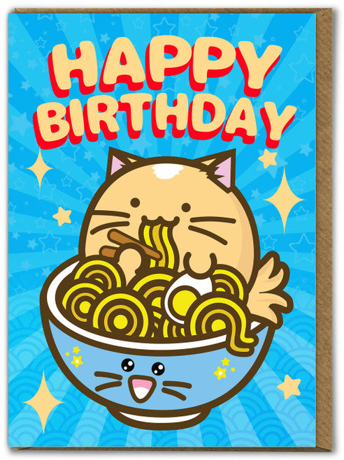 A greetings card with a sky blue background with darker blue sun beams coming from behind the illustration of a round kawaii-style cat eating a bowl of noodles. Above the cat it says the words &#39;happy birthday&#39; in capital letters.