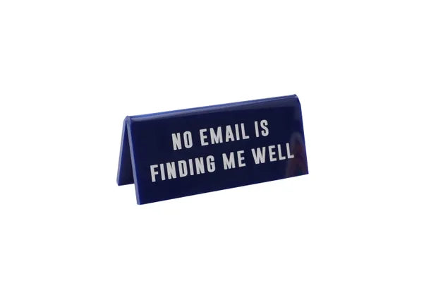 A small navy acrylic sign that has in big white capital letters on it &#39;NO EMAIL IS FINDING ME WELL&#39;.